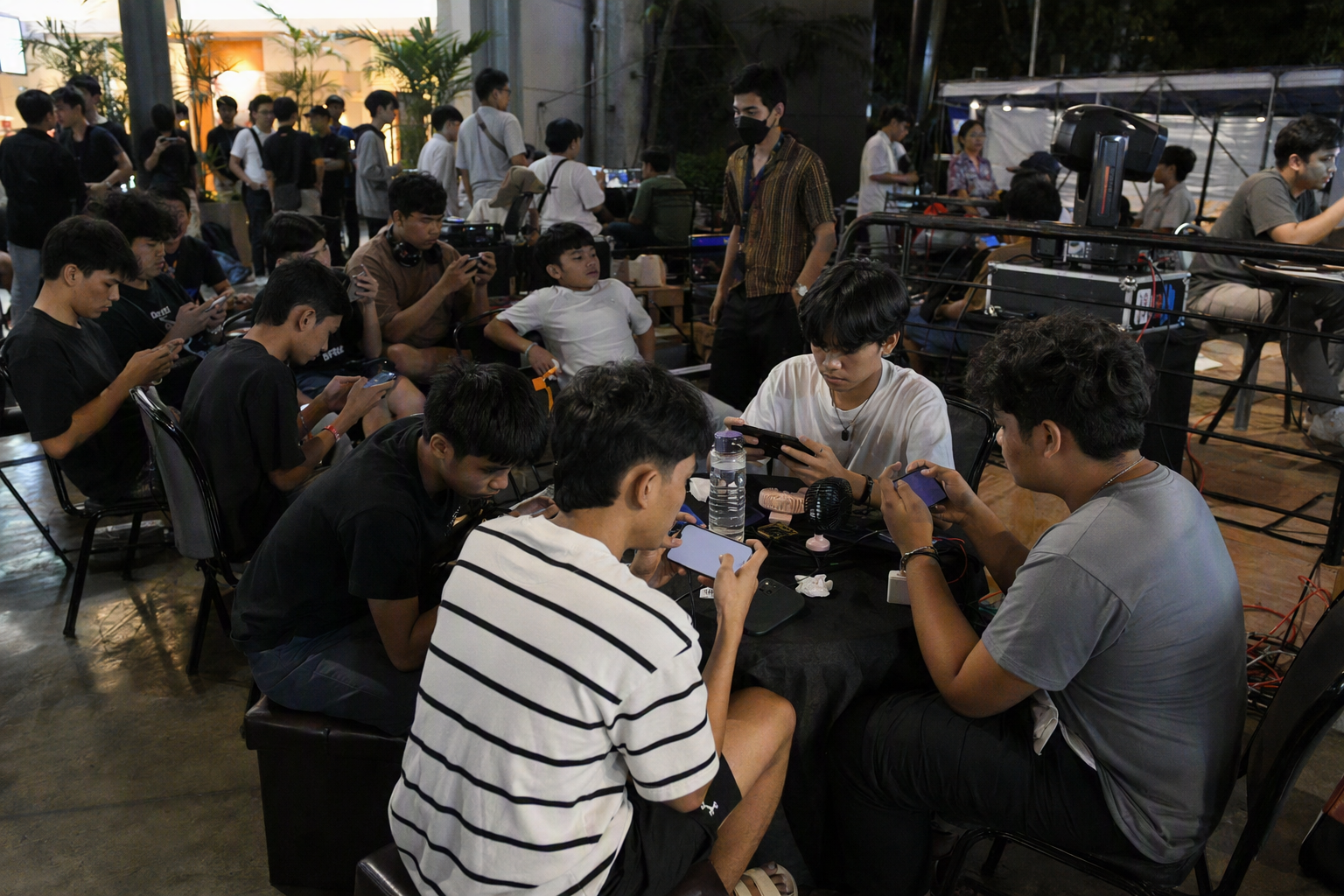 Team captains preparing on mobile phones at a Manila community esports venue