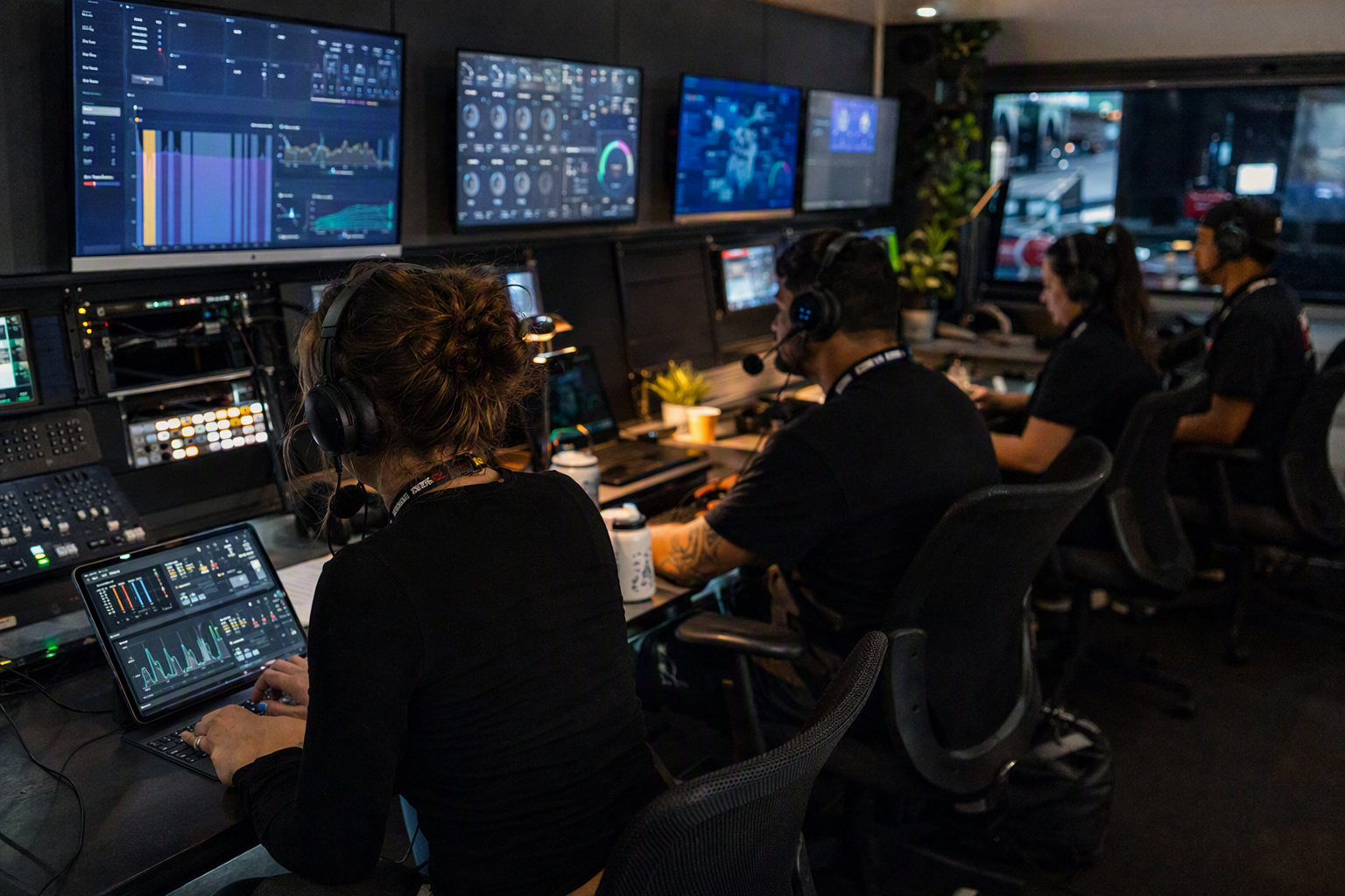 Independent tournament organizers coordinating mobile esports matches from a control desk