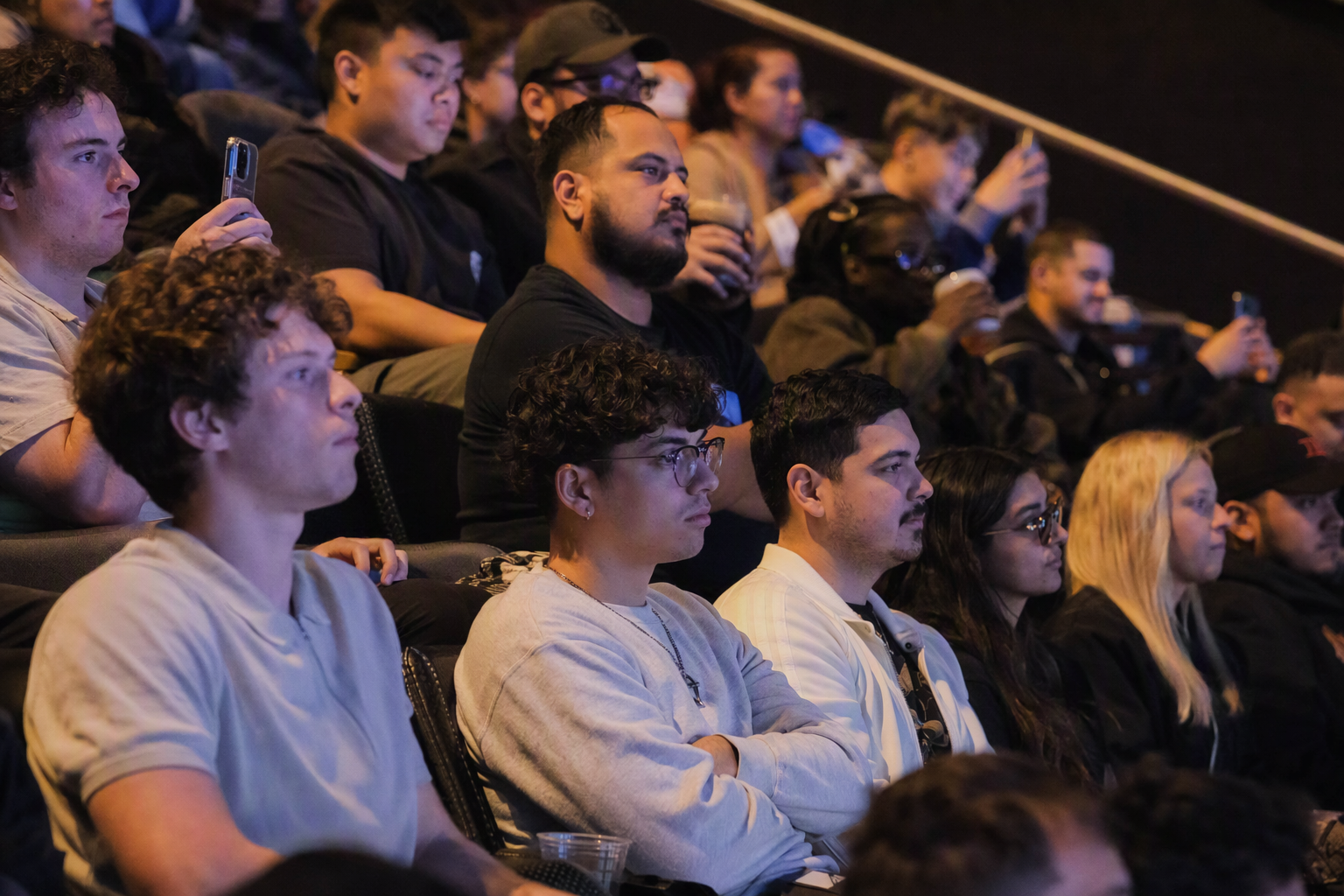 Spectators following an independently operated mobile esports event from a small live audience area